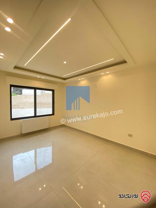 شقة أرضية فاخرة طابق ارضي معلق 90م تشطيب سوبر ديلوكس لم تسكن للبيع في عمان - أم أذينة