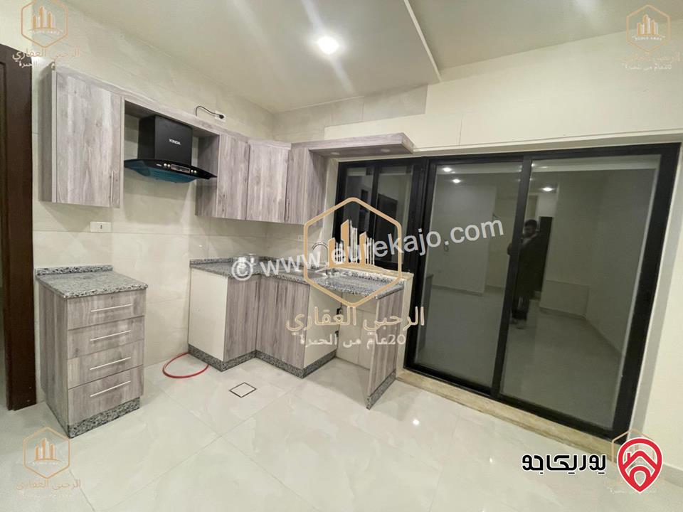 شقة ديلوكس شبه ارضية مساحة 90م مع ترس 50م للايجار في عمان - الجندويل 